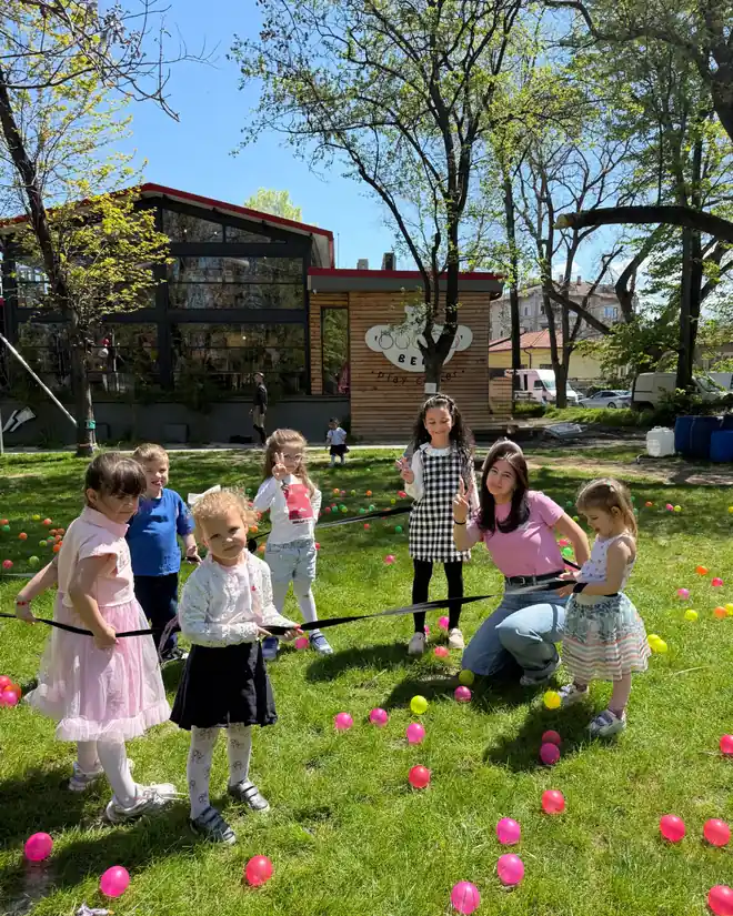 Children playing in the outdoor park area and garden of Bubbu Bear Kids Center in Komatevo Plovdiv